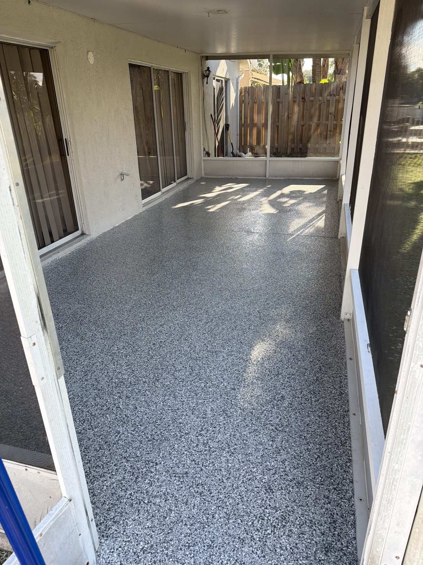 Patio lanai with flake epoxy floor in charcoal and gray