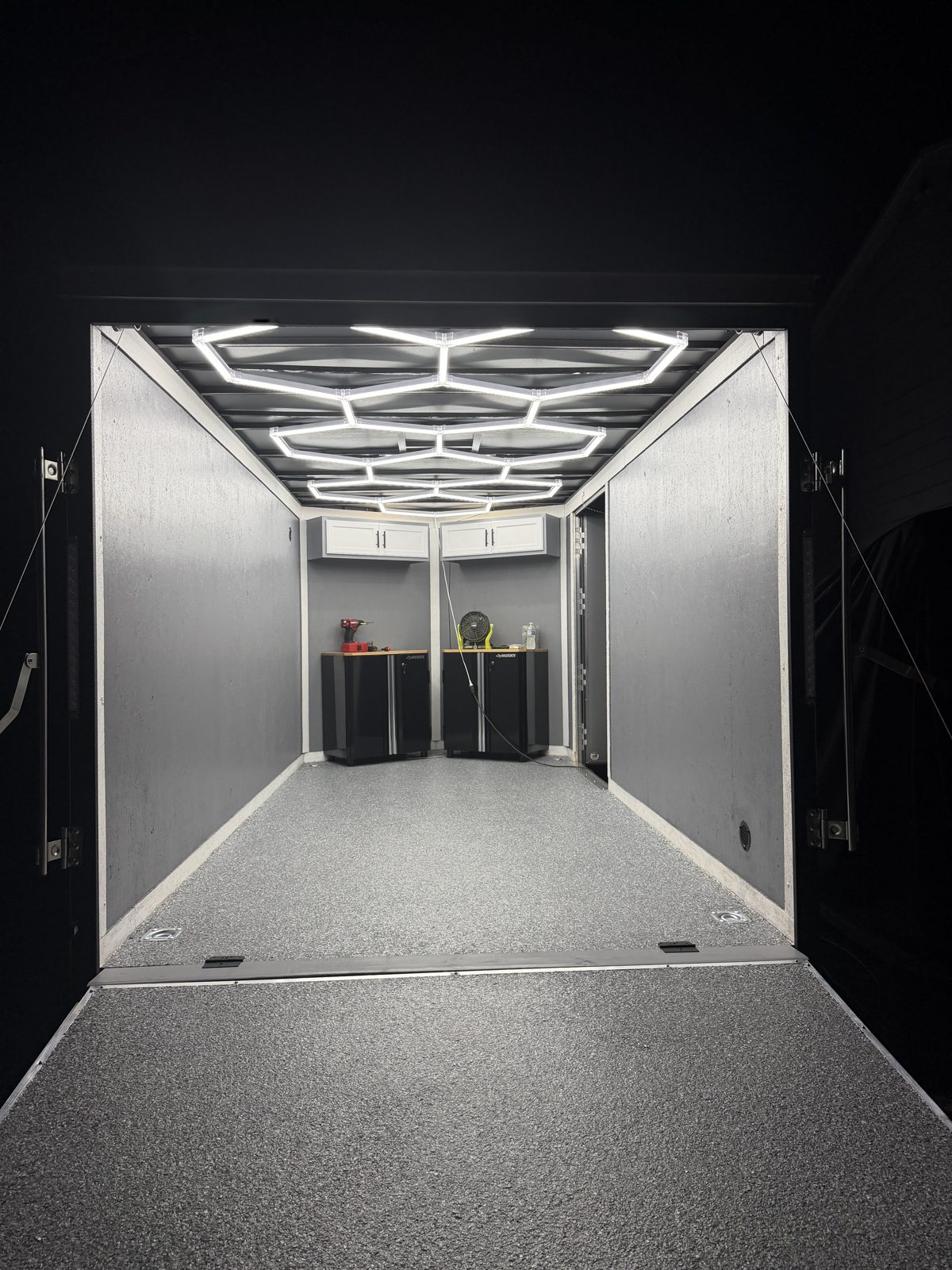 Enclosed cargo trailer with gray flake epoxy floor and ramp, finished by Epoxy and Moore